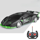 Voiture télécommandée noire et verte avec sa télécommande, présentées sur fond gris